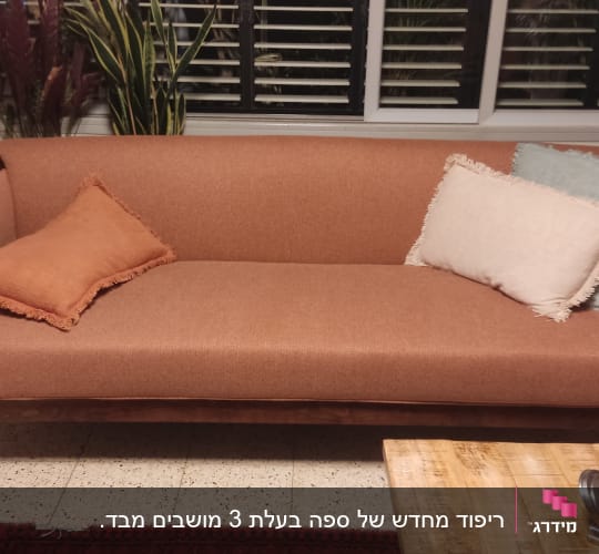 ספה עם כריות בצבעים שונים על מושב מרופד